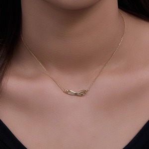 Golden 925 sterling silver infinity pendant necklace with cubic zirconia on female neck