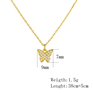 Macro shot of gold butterfly pendant with size labels showing 7mm x 9mm and 38+5cm chain