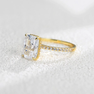 Macro shot of rectangular cut zircon ring with four-prong setting and gold finish