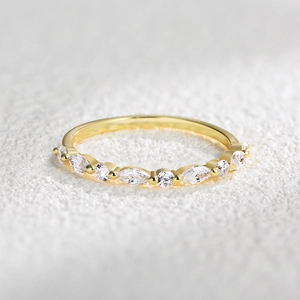 Detail of s925 silver gold-plated ring set with marquise and round cut cubic zirconia