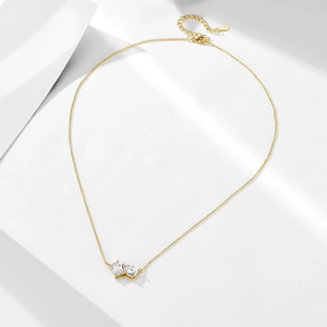 Detail of S925 silver gold necklace with pear and square zircon pendant and lobster clasp