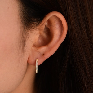 Close-up of elegant gold plated 925 sterling silver bar earrings with white crystals
