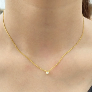 Elegant S925 sterling silver four-prong solitaire necklace worn on a woman's neck