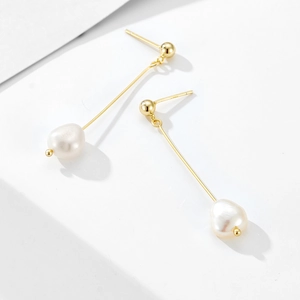 Detailed view of long 925 silver tassel earrings with baroque pearls and gold plating