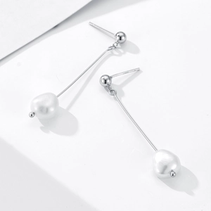 Detailed macro view of S925 sterling silver stamp on long tassel pearl earrings