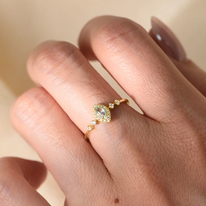 S925 silver ring with sky blue marquise topaz and halo diamonds on gold band