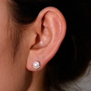 Elegant S925 silver V-shaped pearl stud earring with zircon inlay worn on a model ear