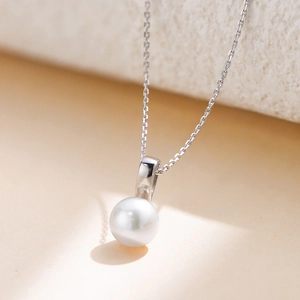 Elegant S925 sterling silver necklace featuring a round natural freshwater pearl pendant