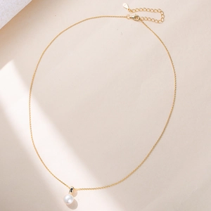 Macro detail of natural freshwater pearl pendant on a gold S925 sterling silver chain