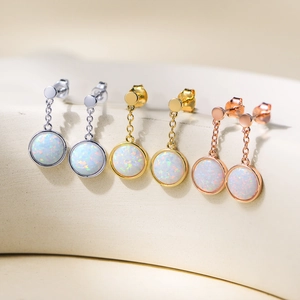 Three pairs of gold-plated opal drop earrings in silver, gold, and rose gold finishes