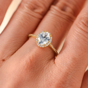 Elegant gold S925 silver ring featuring an oval zircon center stone and halo setting