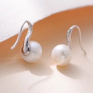 Macro detail of S925 hallmark on silver earrings with natural freshwater pearls