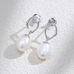 S925 silver irregular geometric earrings with baroque pearls on stone texture surface