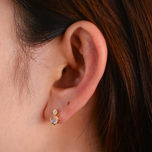 Elegant gold S925 silver stud earrings with natural moonstone and diamond accents on ear