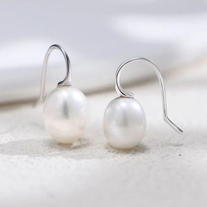 Close-up of elegant S925 silver hook earrings with natural teardrop Baroque pearls