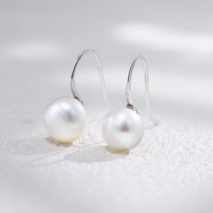 Macro view of natural freshwater pearl earrings with elegant S925 silver hooks