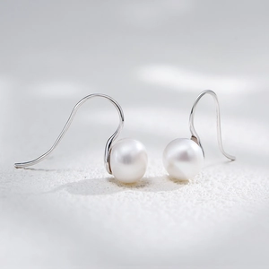 Elegant natural freshwater pearl earrings with S925 sterling silver hooks on white surface