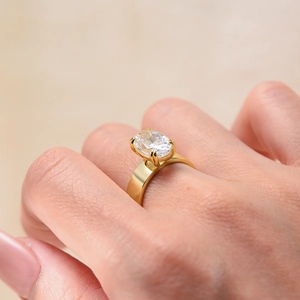Close-up of a gold s925 silver ring with a large oval ice-cut cubic zirconia in 4-prong setting