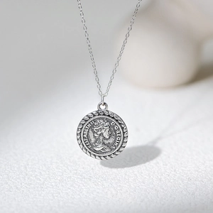 Macro shot of S925 sterling silver Elizabeth II relief on a vintage coin pendant necklace