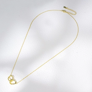 Detailed close-up of 925 sterling silver stamp on golden twisted double ring necklace