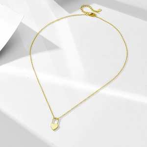 Macro shot of 925 sterling silver heart lock pendant with adjustable gold lobster clasp