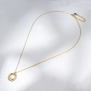 Detail of S925 sterling silver stamp on golden double ring necklace with zircons