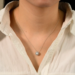 Elegant S925 silver necklace with round natural pearl and blue zircon pendant on model