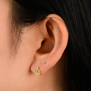 925 silver gold crown stud earrings with sparkling cubic zirconia on a female ear
