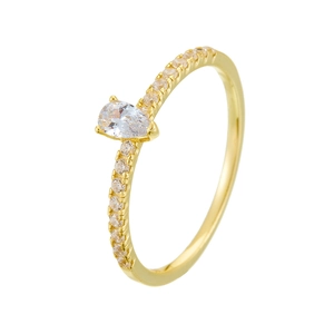 Detail of pear-cut zircon ring with gold band and side diamond accents on white background
