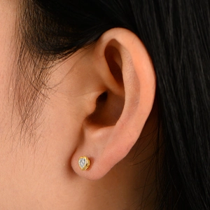 Minimalist S925 sterling silver heart stud earrings with cubic zirconia on model ear