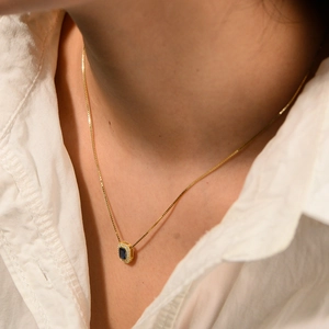 S925 silver gold necklace with rectangle blue zircon pendant on a model neck
