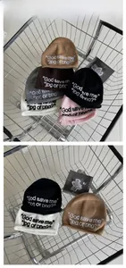 Detail of embroidered knit beanies in multiple colors on an industrial shopping cart