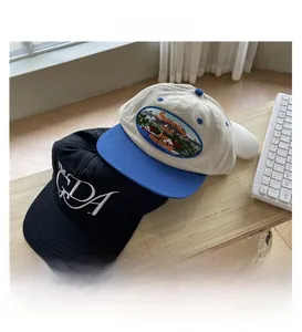 Detail of embroidered hip-hop flat brim hats with vintage lettering and scenic patch