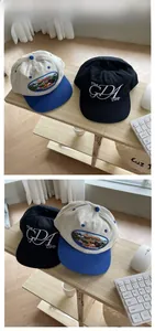 Close-up of embroidered vintage baseball caps in two-tone blue-beige and solid black options
