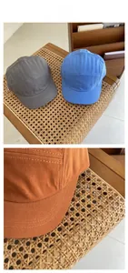 Detail of multi-color 5-panel soft cotton baseball caps showing stitching and canvas texture