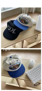 Detail of embroidered street style baseball caps showing high-density cotton and scenery stitching