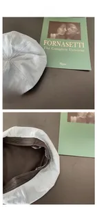 Detail of light blue denim beret showing inner black lining and Irin-ye patch logo