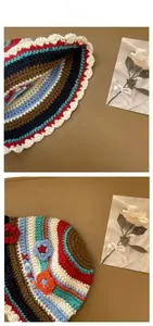 Close-up of handmade crochet bucket hat with colorful stripes and 3D floral details