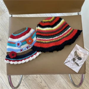 Handmade striped crochet bucket hat with floral detail and wavy brim for winter