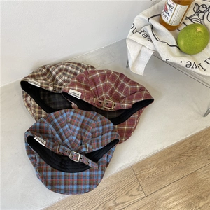 Vintage plaid newsboy hats with leather straps in yellow, red, and blue checkered patterns