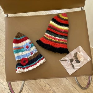 Handmade crochet striped bucket hat with floral detail and vintage winter warmth design