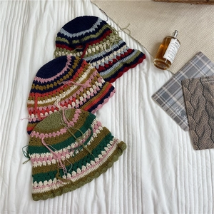 Handmade striped crochet bucket hat with colorful tassels and retro fringe detail