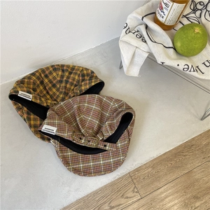 Retro plaid newsboy caps in yellow and purple tweed with adjustable metal buckles