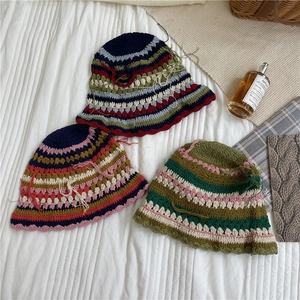 Handmade crochet boho bucket hat with colorful stripes and tassels for a retro aesthetic