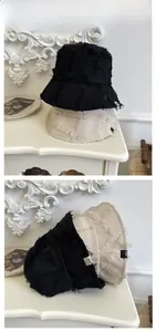 Detail shot of raw edges and vintage brand label on foldable cotton bucket hats