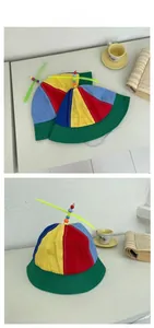 Detail view of a colorful kids propeller bucket hat with vibrant patchwork and bead decor