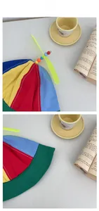 Flat lay of colorful patchwork kids bucket hat with a yellow spinning propeller on top