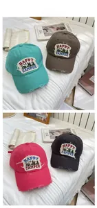 Detail display of vintage washed denim baseball caps with Happy Camper embroidery patches