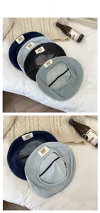 Detail showing high-quality denim beret texture with a classic metal NK brand tag
