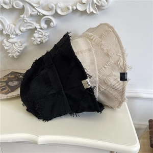 Frayed edge canvas bucket hats in black and beige with vintage aesthetic patch
